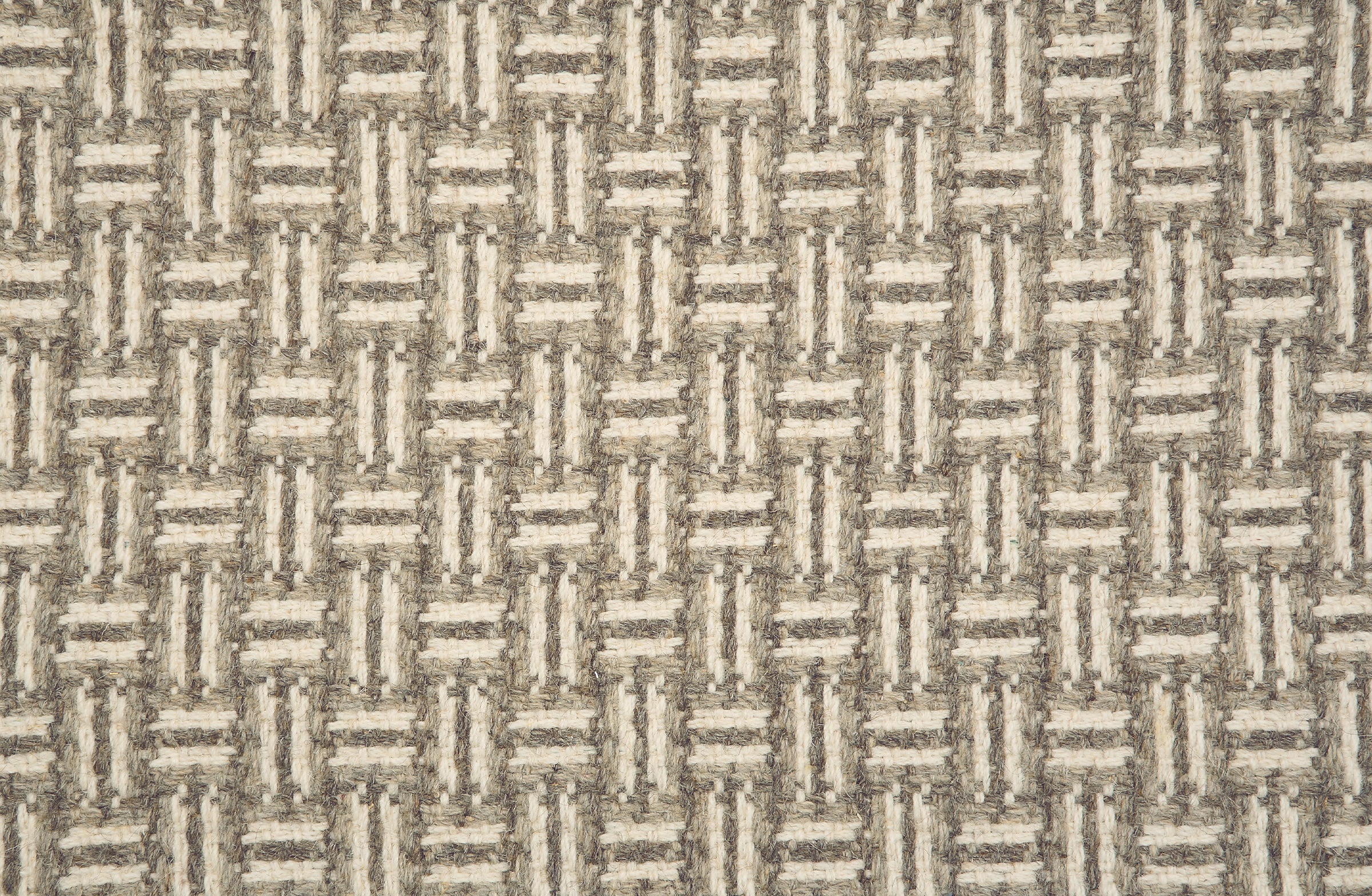 Broadloom carpet with a geometric herringbone design in cream, grey and taupe.