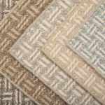 Collection of textured rugs with geometric patterns in neutral colors.