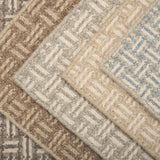 Collection of textured rugs with geometric patterns in neutral colors.
