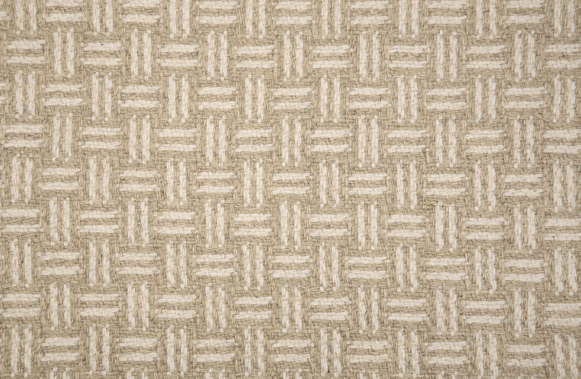 Broadloom carpet with a geometric herringbone design in cream, and beige.