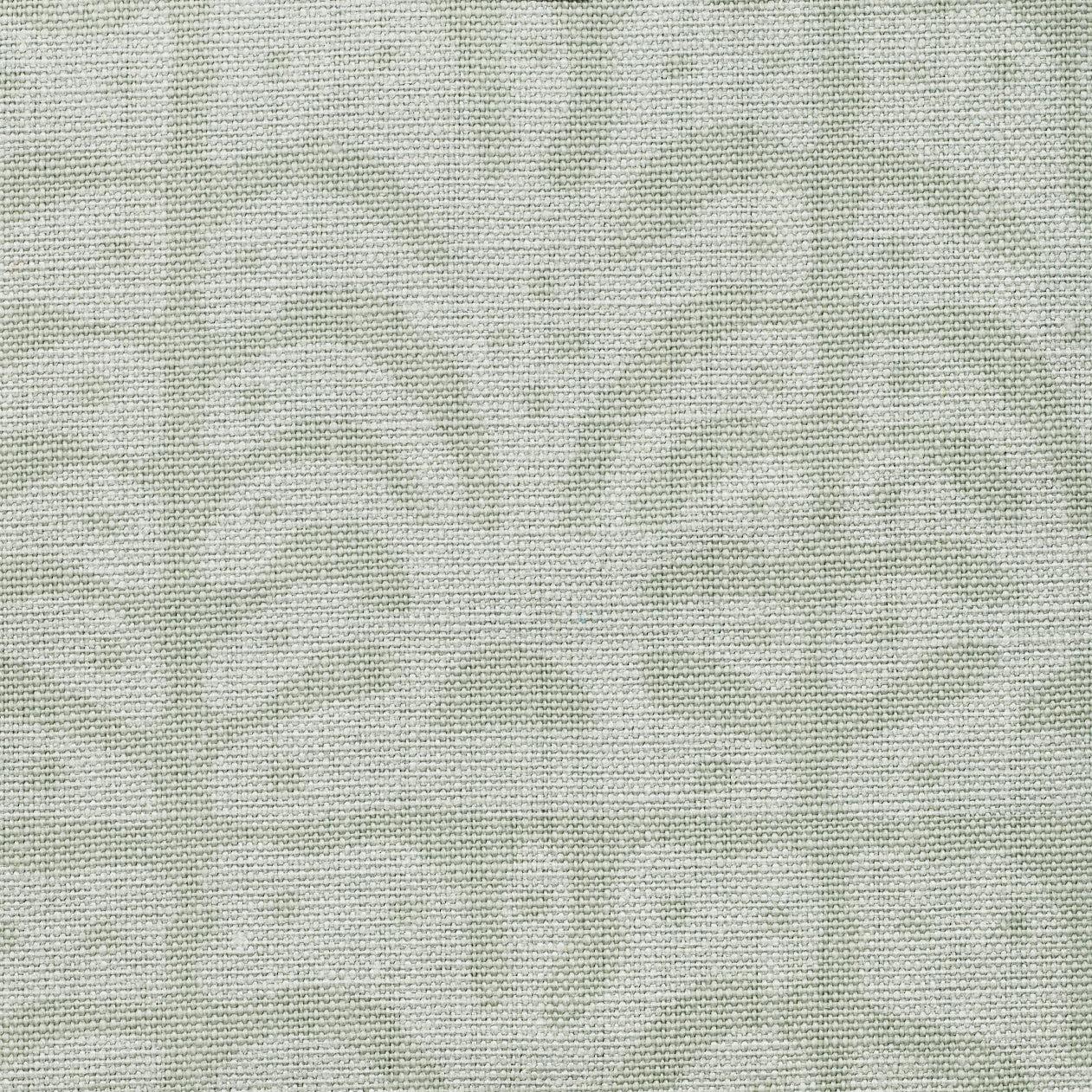 Detail of fabric in an abstract leaf print in light green and gray.