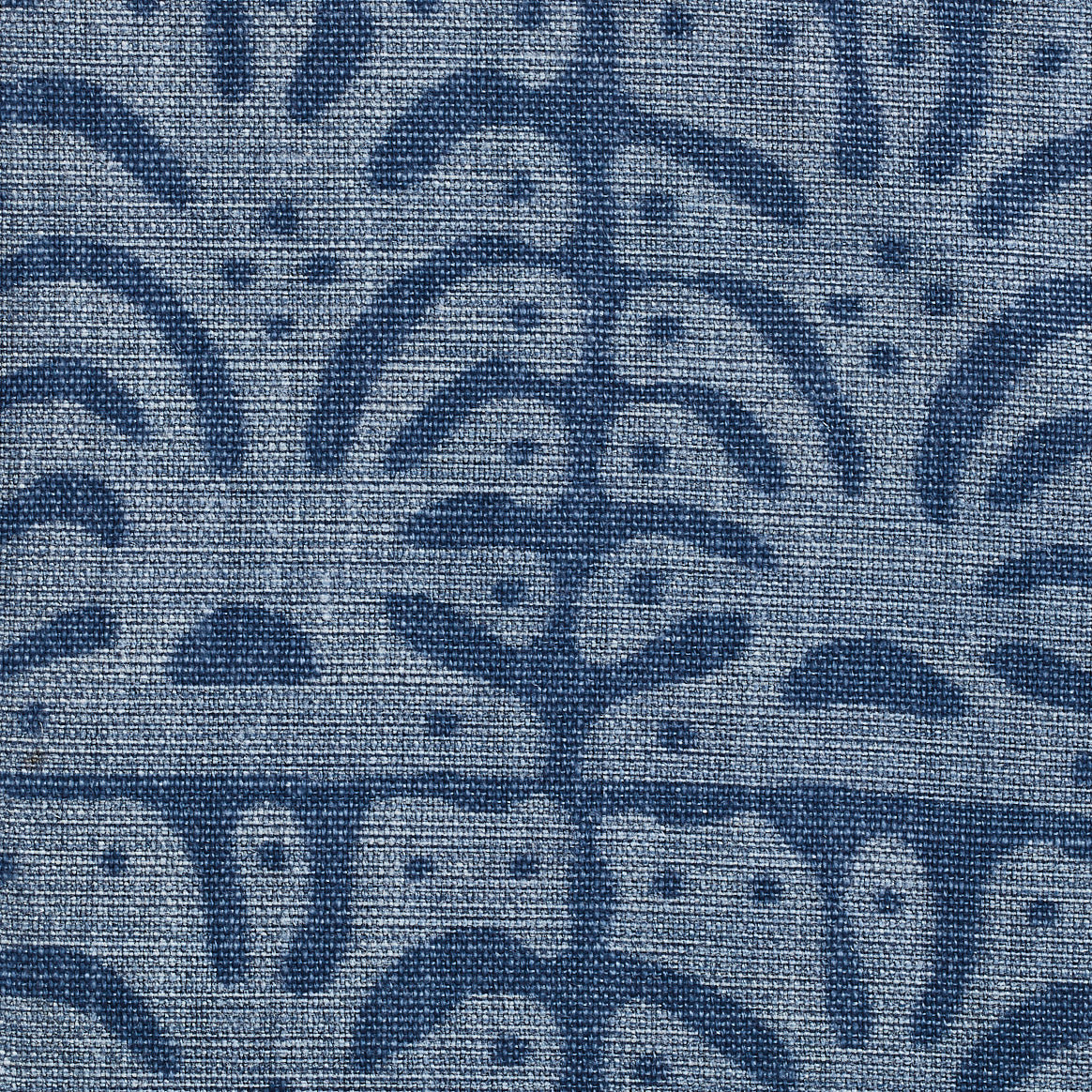 Detail of fabric in an abstract leaf print in blue on a navy field.