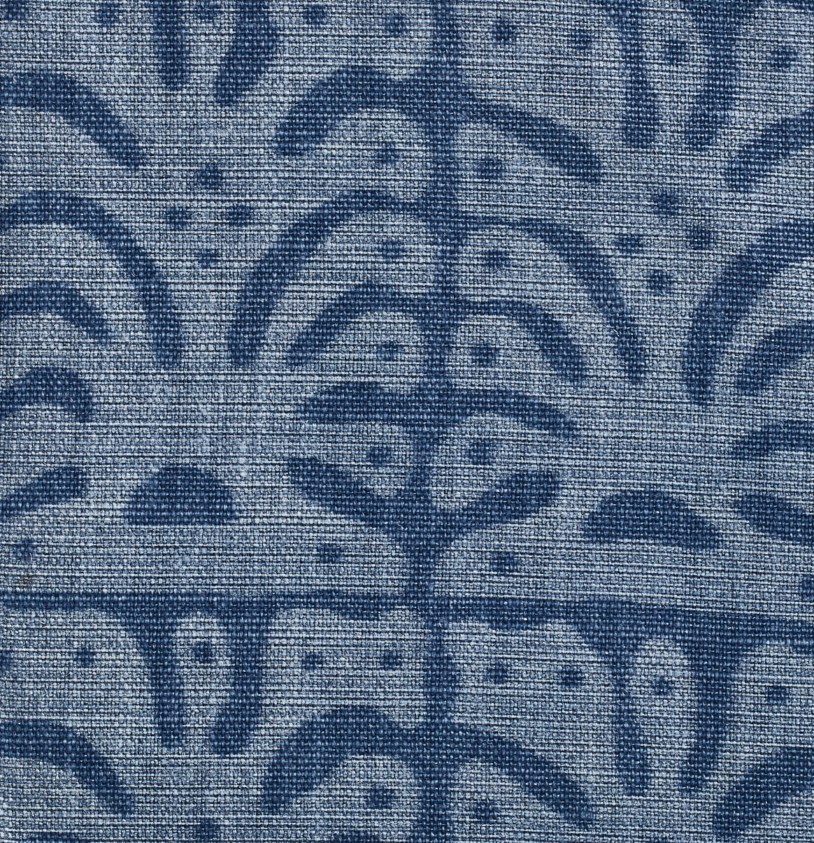 Detail of fabric in an abstract leaf print in blue on a navy field.