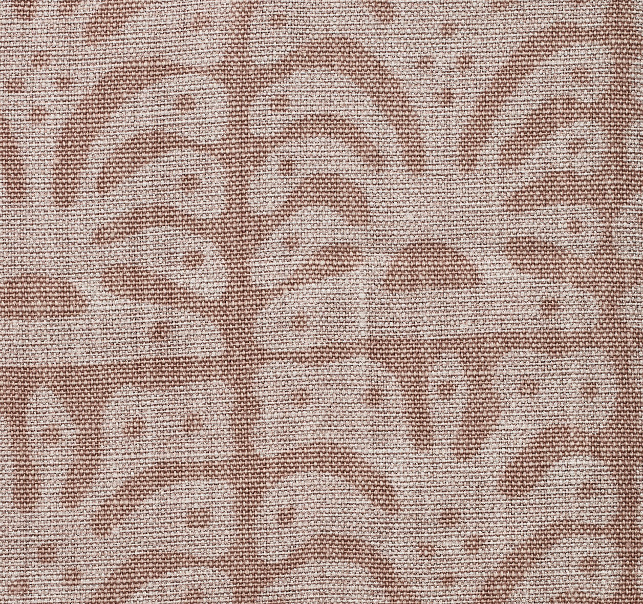 Detail of fabric in an abstract leaf print in tan on a brown field.