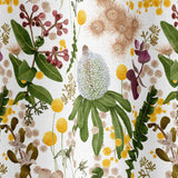 Draped fabric in a large-scale botanical print in shades of pink, yellow and green on a cream field.