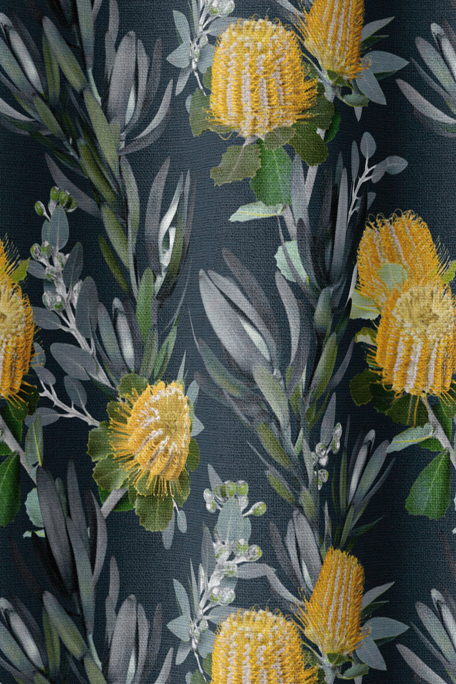 Draped fabric in a photorealistic floral print in shades of yellow, white and green on a navy field.