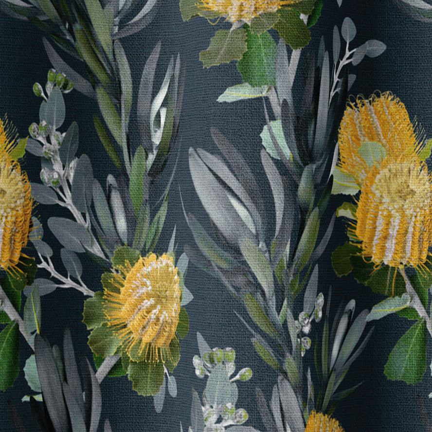 Draped fabric in a photorealistic floral print in shades of yellow, white and green on a navy field.