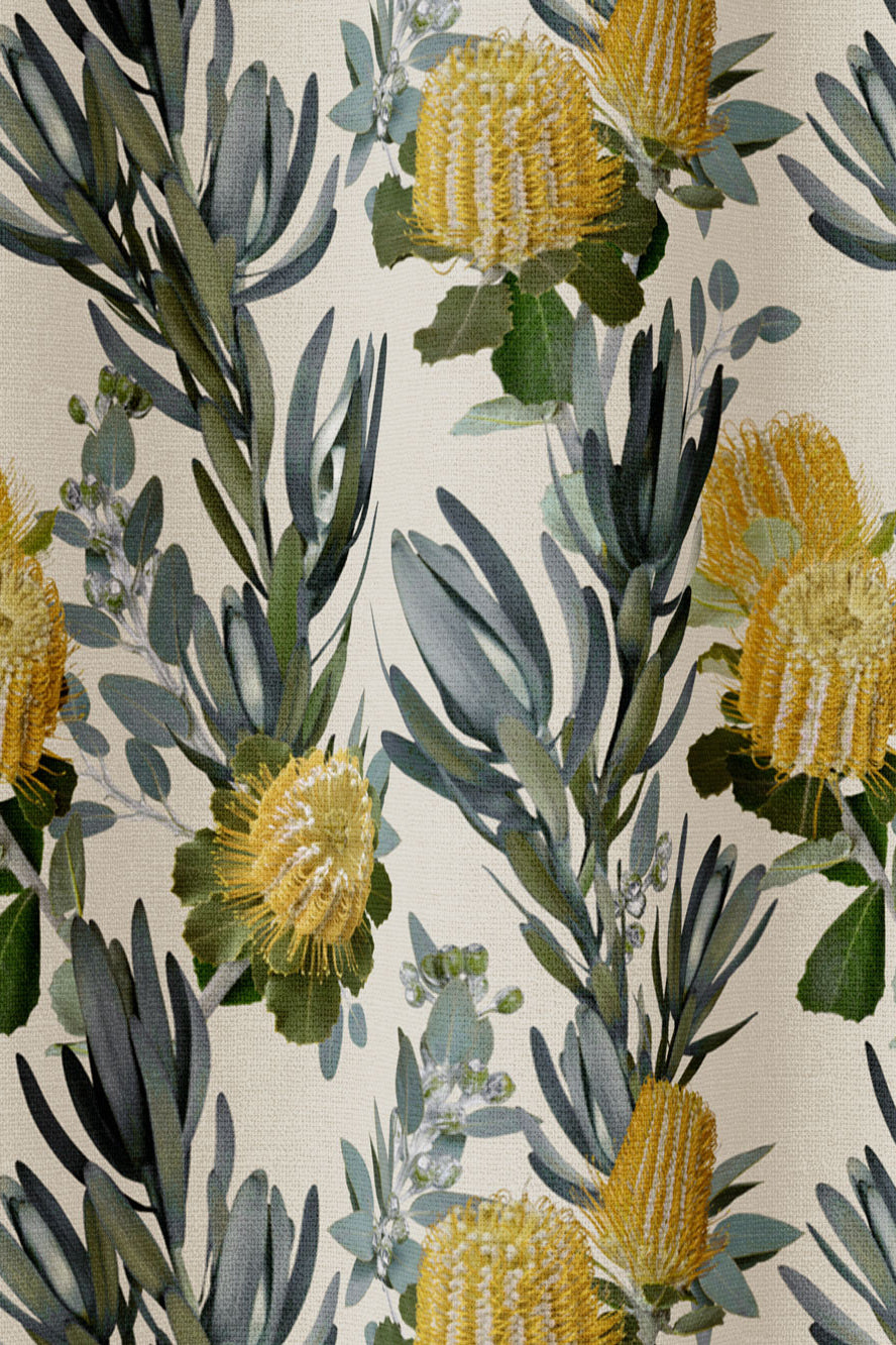 Draped fabric in a photorealistic floral print in shades of yellow, white and green on a cream field.