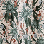 Draped fabric in a large-scale botanical print in shades of blue, turquoise and red on a cream field.