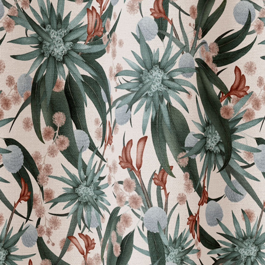 Draped fabric in a large-scale botanical print in shades of blue, turquoise and red on a cream field.