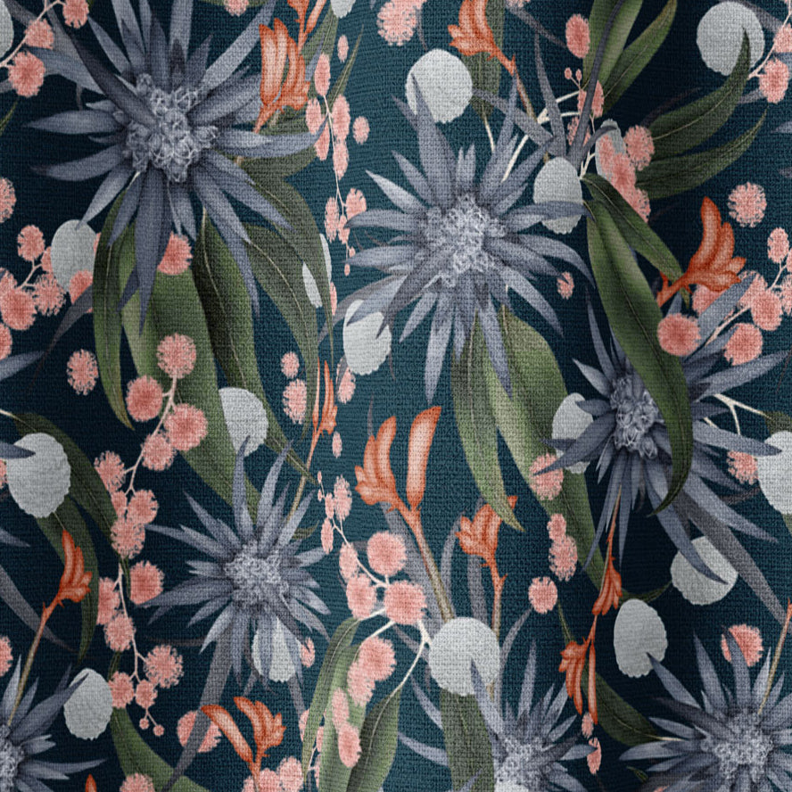 Draped fabric in a large-scale botanical print in shades of blue, green and coral on a navy field.