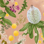 Detail of wallpaper in a large-scale botanical print in shades of pink, yellow and green on a coral field.