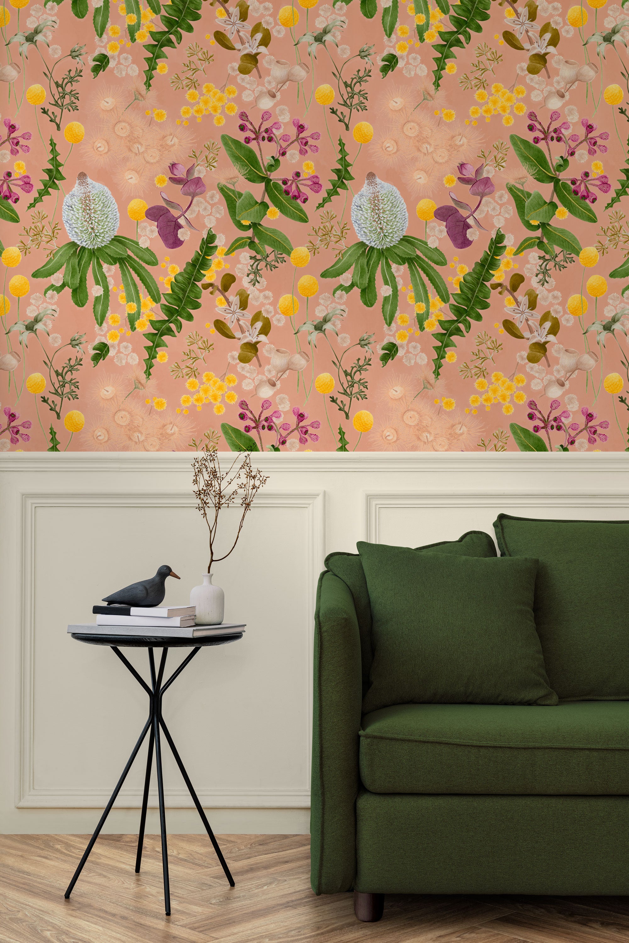 A maximalist living room with a wall papered in a large-scale botanical print in pink, yellow, green and coral.