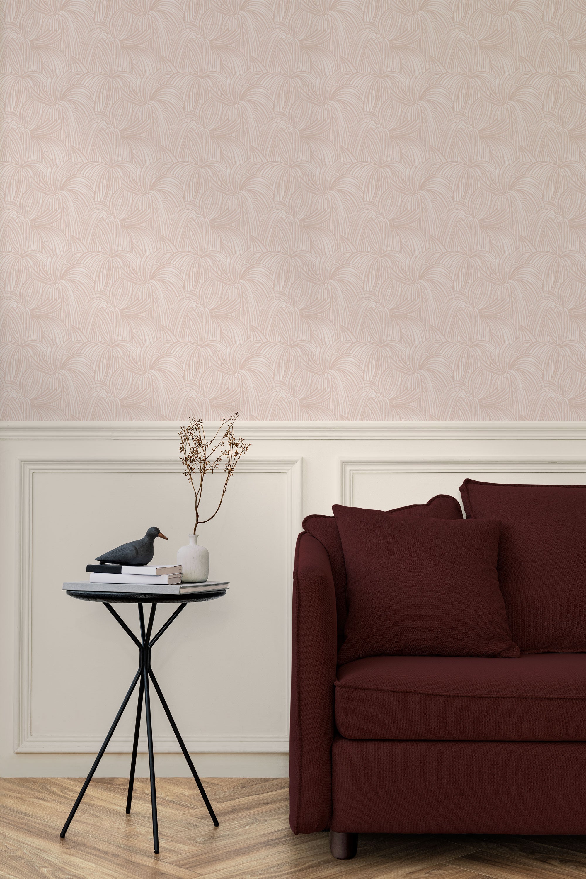 Living room with a wall papered in a textural painted print in blush on a cream field.