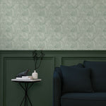 Living room with a wall papered in a textural painted print in sage on a cream field.