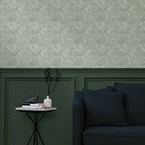 Living room with a wall papered in a textural painted print in sage on a cream field.