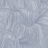 Detail of wallpaper in a textural painted print in blue on a cream field.