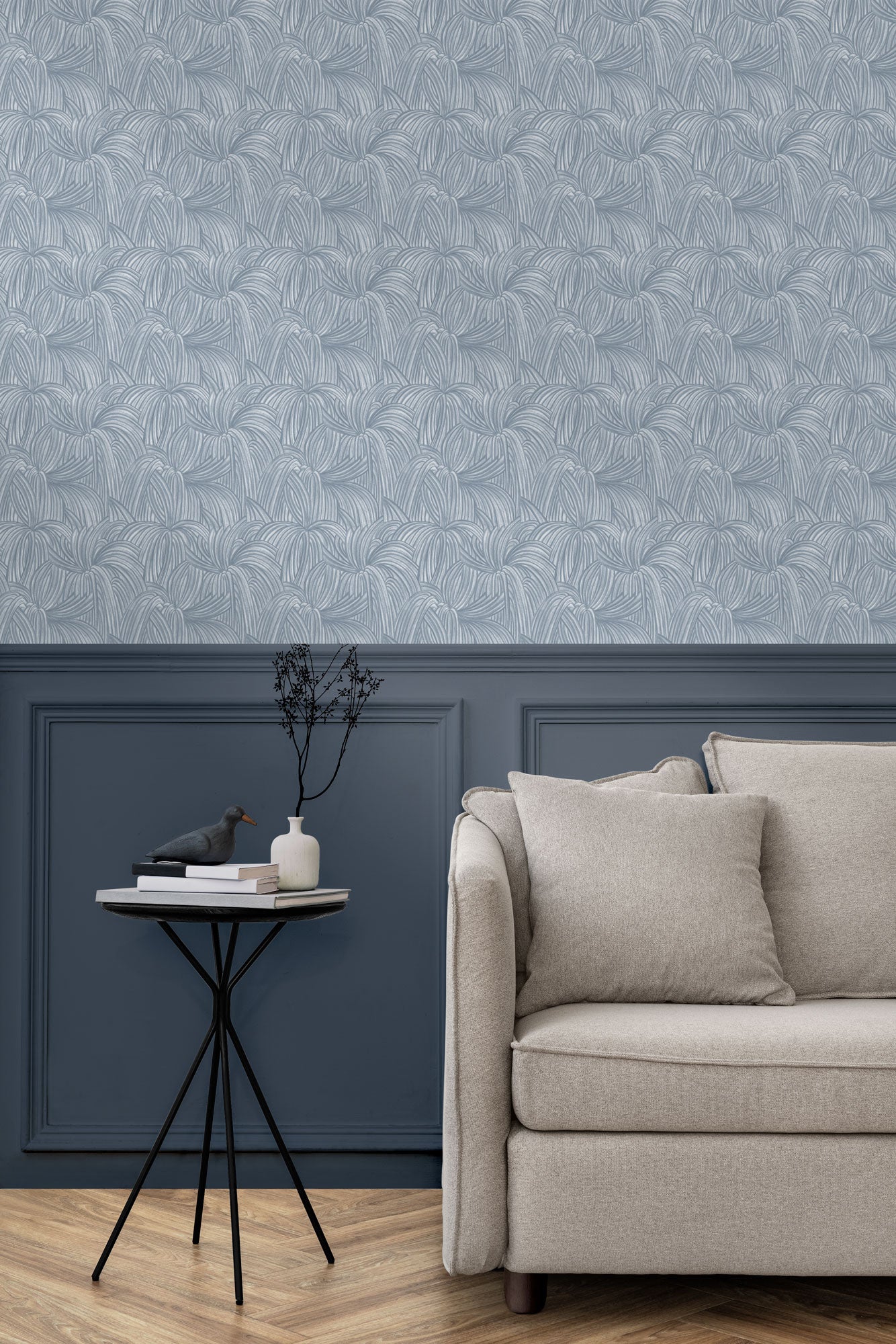 Living room with a wall papered in a textural painted print in blue on a cream field.