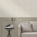 Living room with a wall papered in a textural painted print in tan on a cream field.
