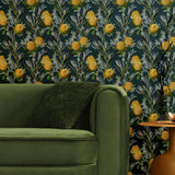 A maximalist living room with a wall papered in a photorealistic floral print in yellow, white, green and navy.