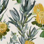 Detail of wallpaper in a photorealistic floral print in shades of yellow, white and green on a cream field.