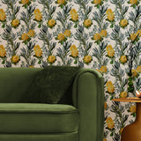 A maximalist living room with a wall papered in a photorealistic floral print in yellow, white, green and cream.