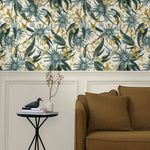 Living room with a wall papered in a large-scale botanical print in blue, turquoise, yellow and cream.