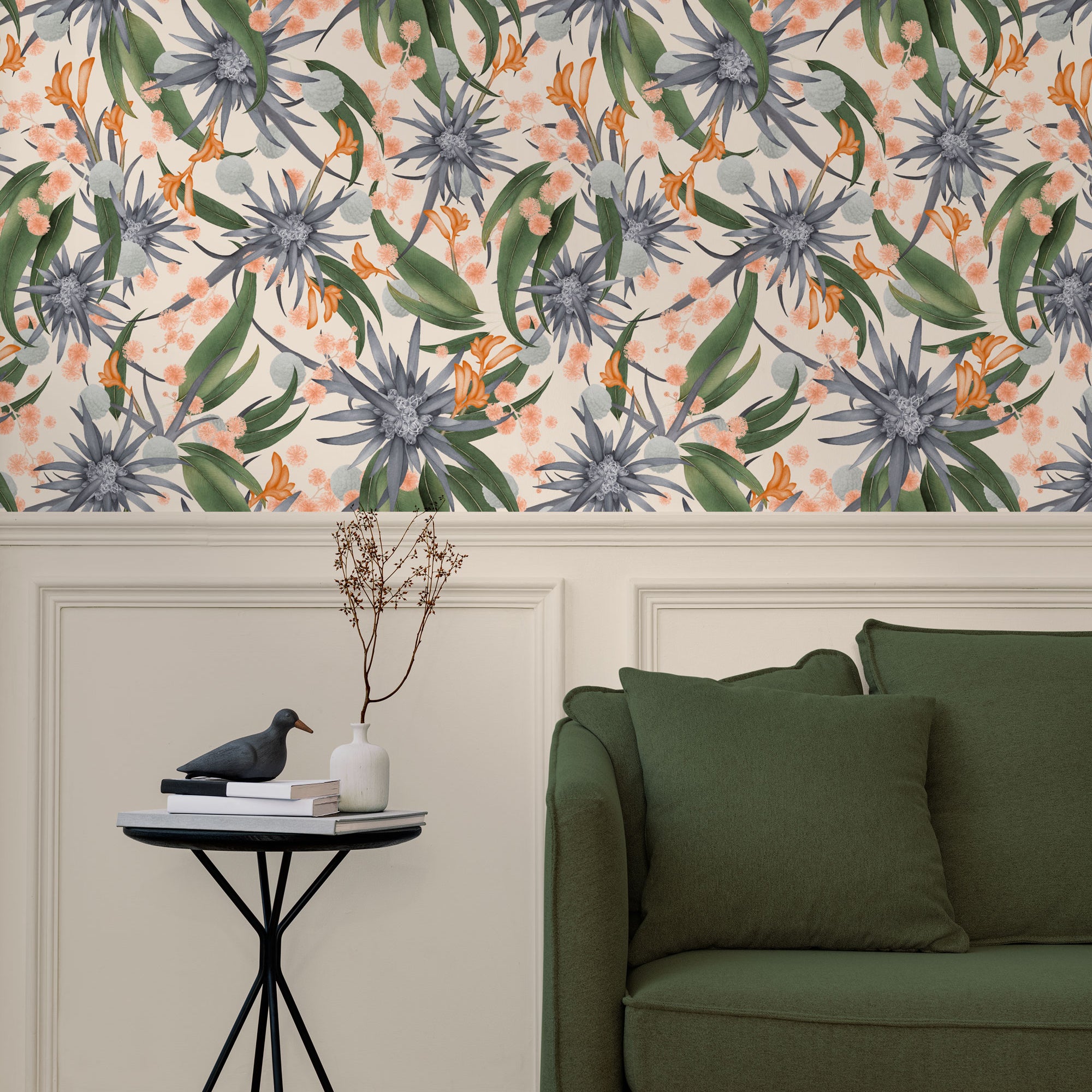 Living room with a wall papered in a large-scale botanical print in blue, green, coral and cream.