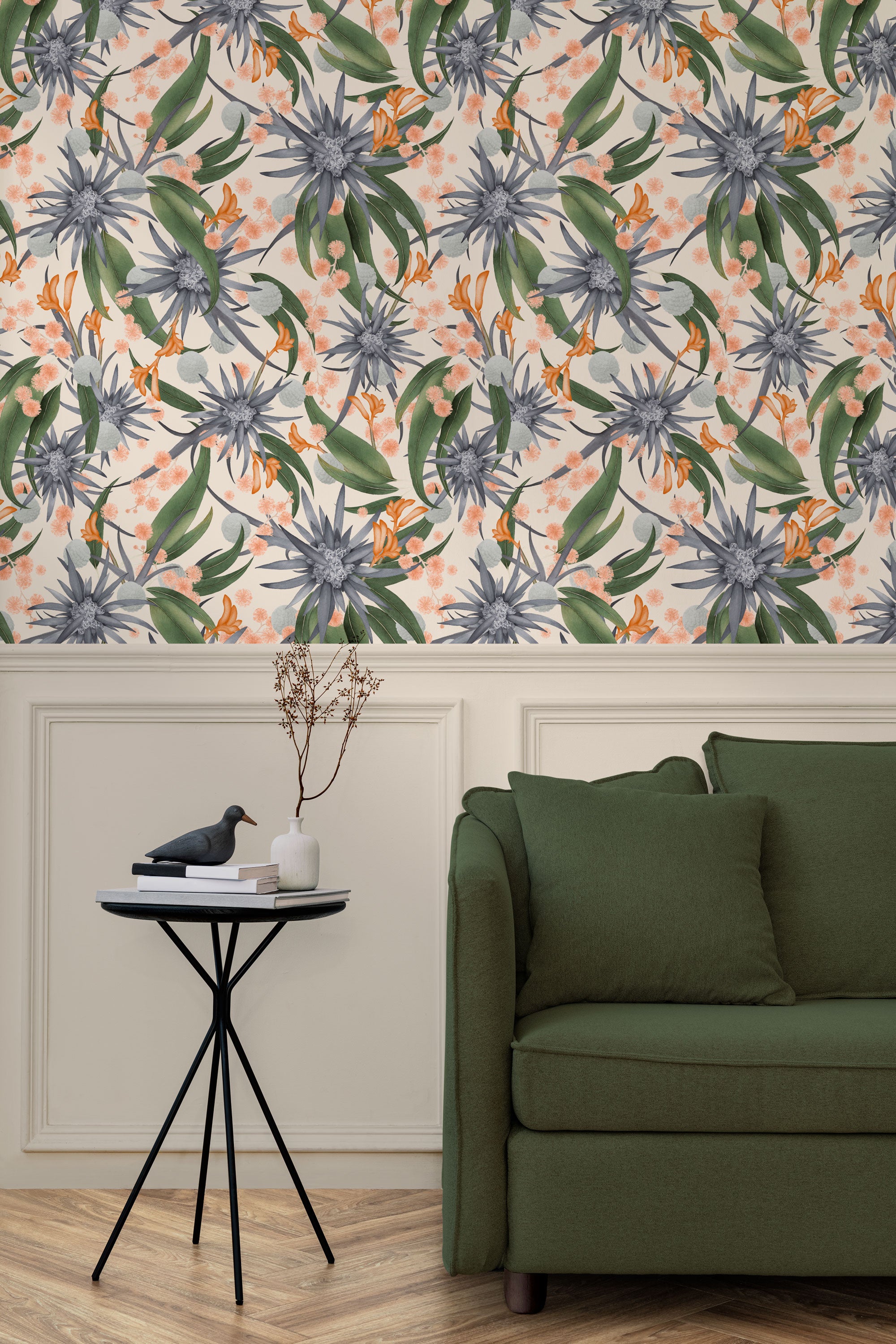 Living room with a wall papered in a large-scale botanical print in blue, green, coral and cream.