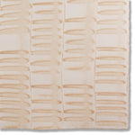 Detail of a hand-painted wallpaper swatch with an undulating ribbon pattern in peach.