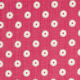 Detail of fabric in a playful dot print in cream and charcoal on a maroon field.