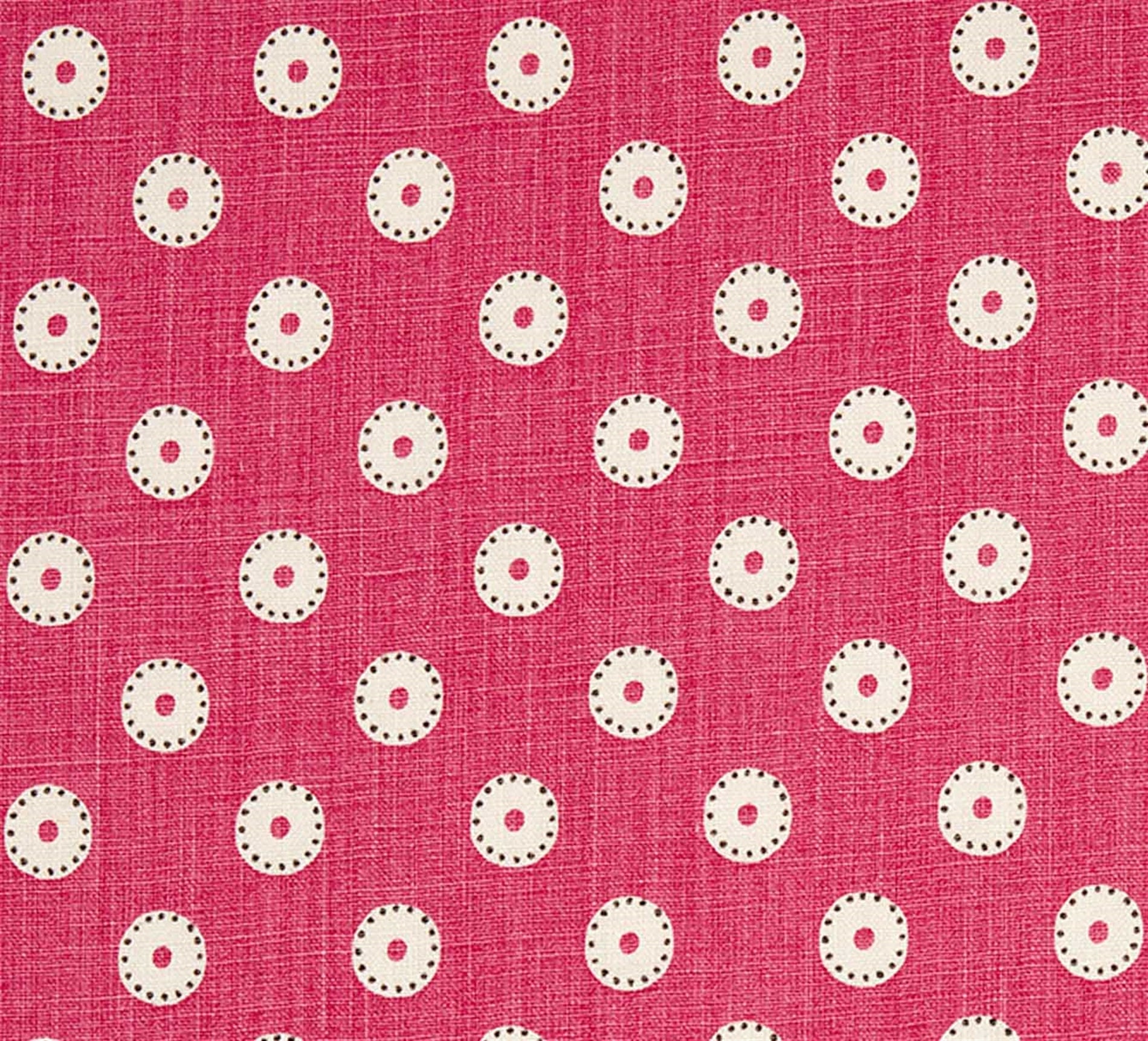 Detail of fabric in a playful dot print in cream and charcoal on a maroon field.