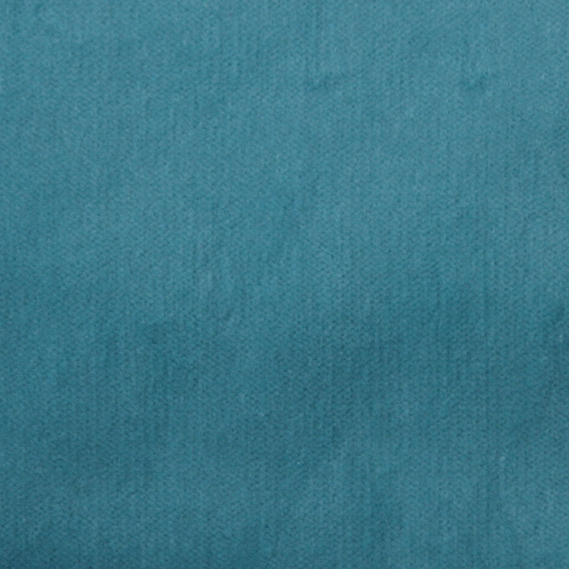 Detail of velvet fabric yardage in turquoise.