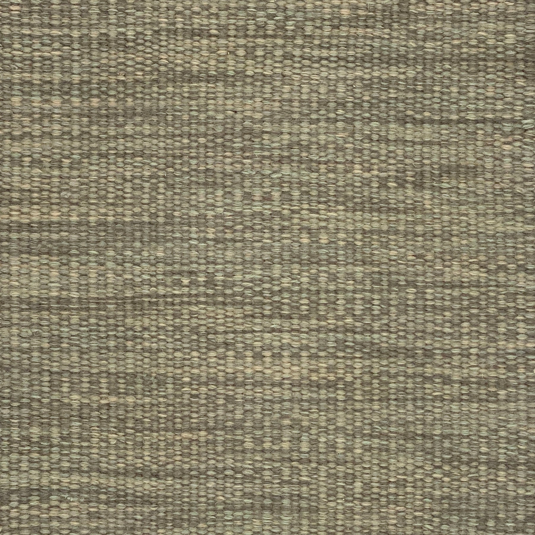 Textured flatweave carpet in sage green. 
