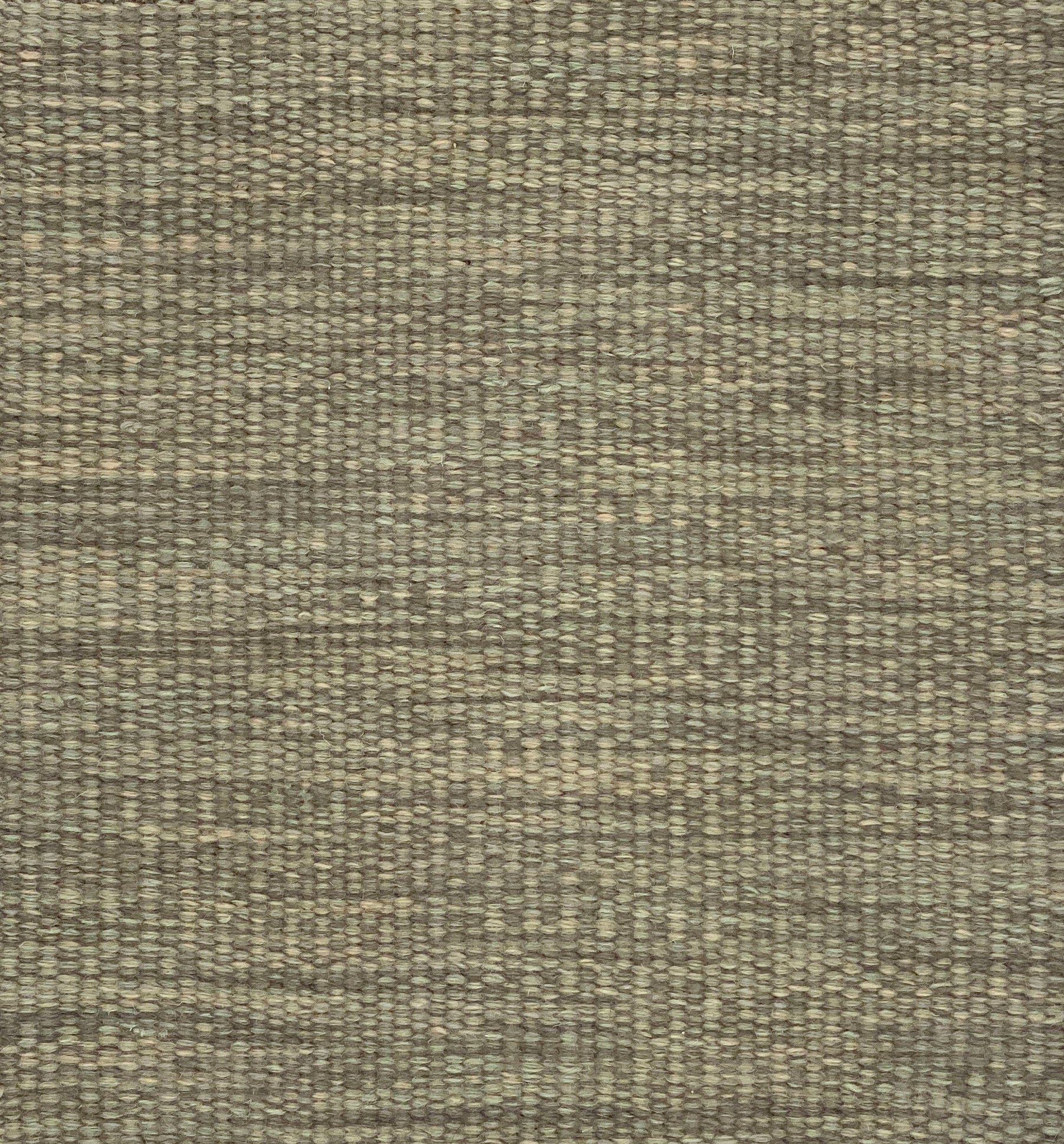 Textured flatweave carpet in sage green. 