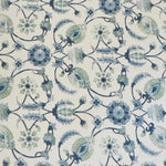 Detail of fabric in a floral paisley print in shades of navy and green on a cream field.