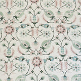 Detail of fabric in a floral paisley print in shades of pink and green on a cream field.