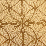 Detail of fabric in a botanical geometric print in shades of tan and brown.