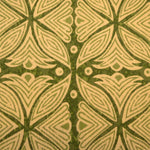 Detail of fabric in a botanical geometric print in shades of tan and green.