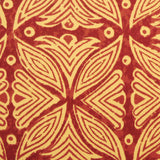 Detail of fabric in a botanical geometric print in shades of mustard and red.