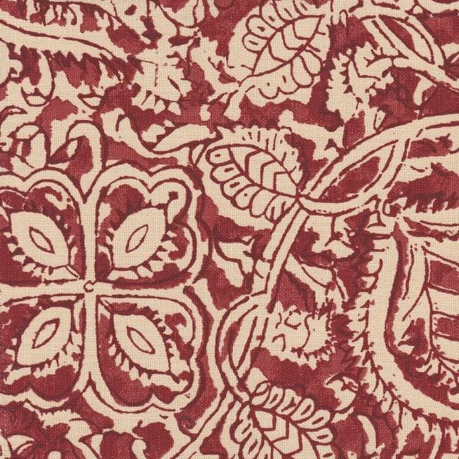 Detail of fabric in a painterly floral paisley in shades of red on a tan field.