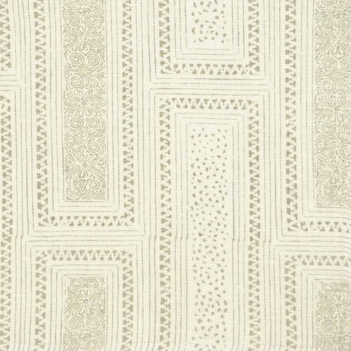 Detail of fabric in a complex interlocking geometric print in light brown on a cream field.