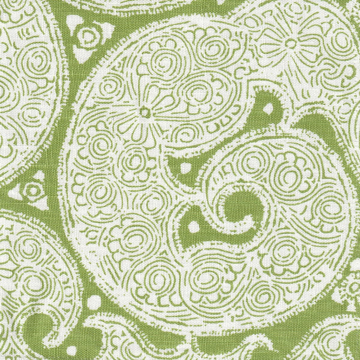 Detail of fabric in a paisley print in white on a green field.