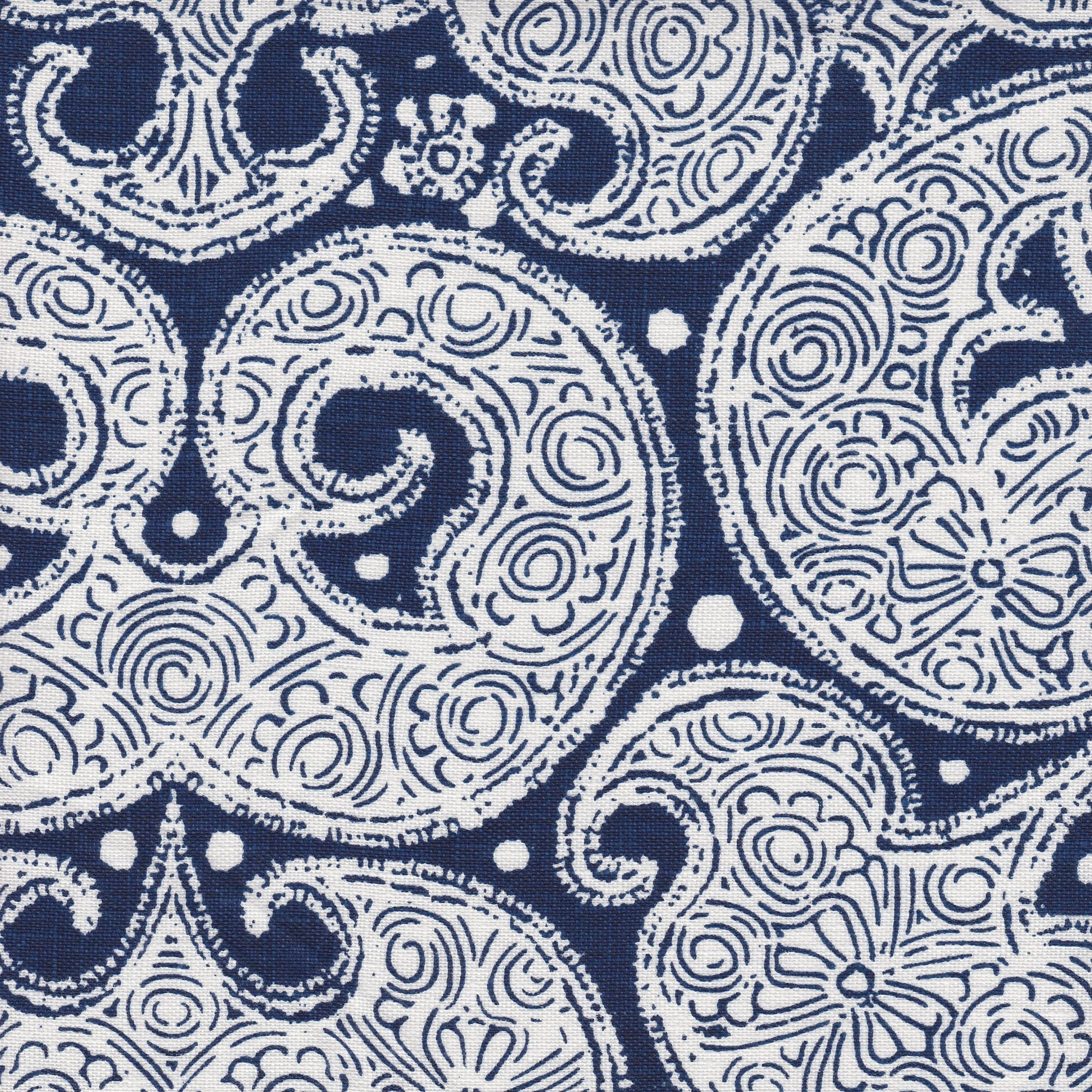 Detail of fabric in a paisley print in white on an indigo field.