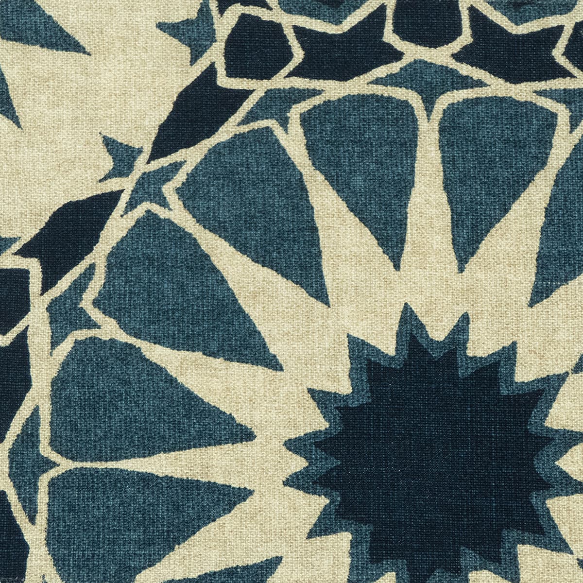 Detail of fabric in a geometric Moroccan print in shades of navy, black and tan.