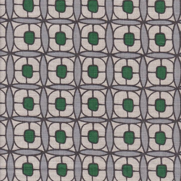 Detail of fabric in a geometric lattice print in green, blue-gray and brown.