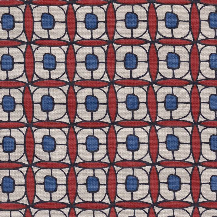 Detail of fabric in a geometric lattice print in red, navy, brown and black.