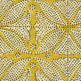 Detail of fabric in a botanical geometric print in shades of yellow and white with a brown dot overlay.