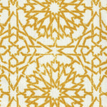 Detail of fabric in a small-scale lattice print in mustard on a white field.