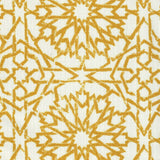 Detail of fabric in a small-scale lattice print in mustard on a white field.